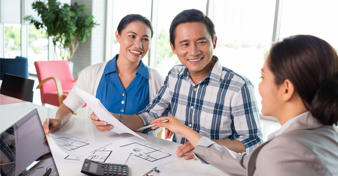 Real Estate Agent and Couple Looking at Homes