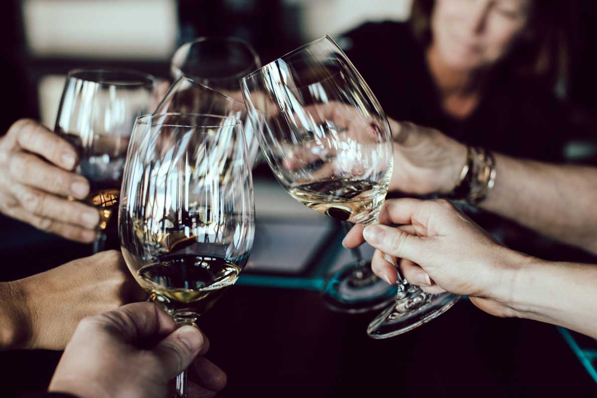 People clinking wine glasses for a toast