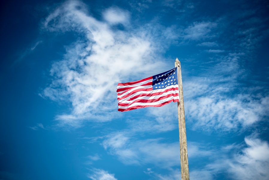 American flag with blue sky in background