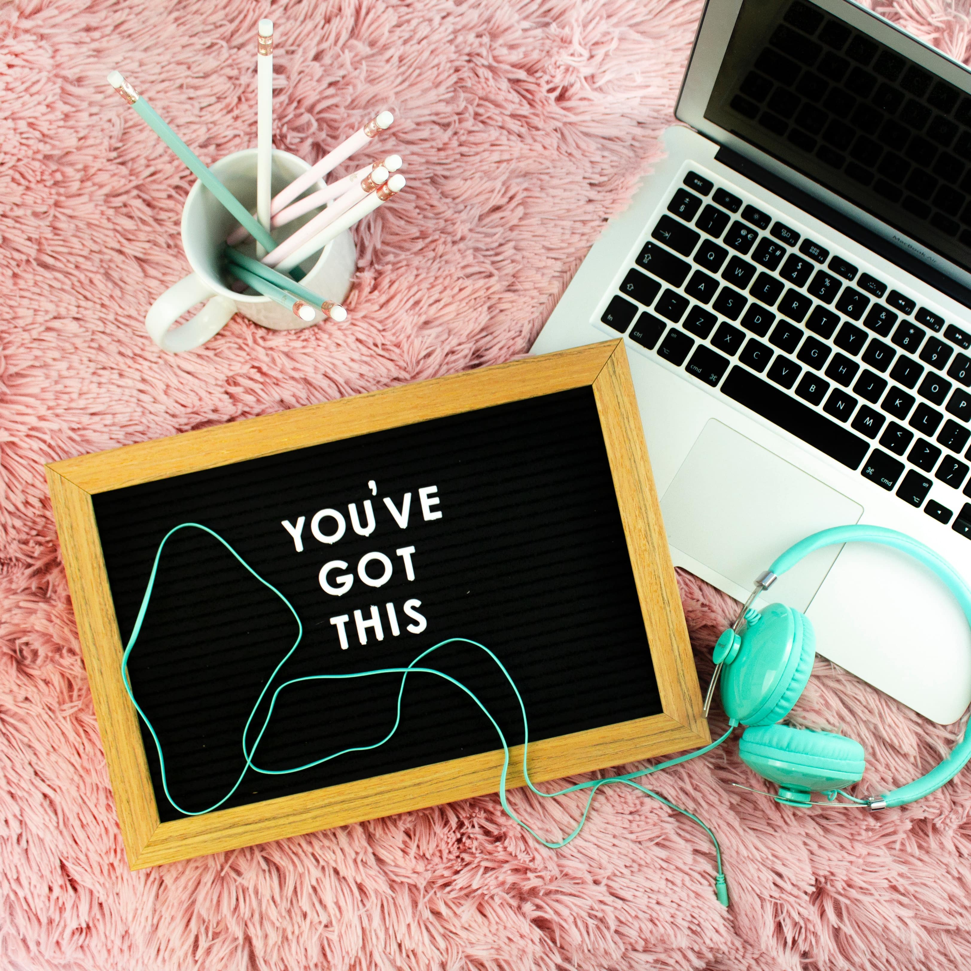 Laptop, headphones, and chalkboard that says “You’ve Got This”