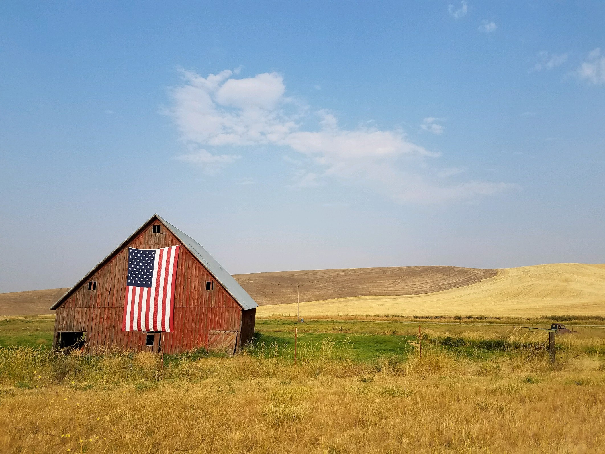 house in field with American flag