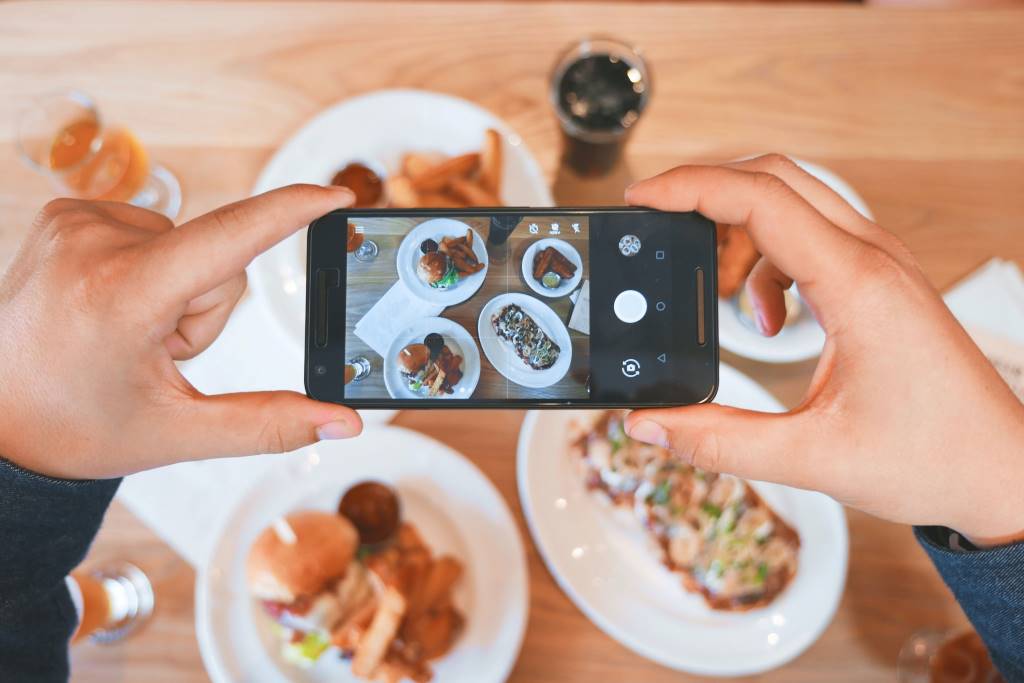 Taking a photo of food at a restaurant.