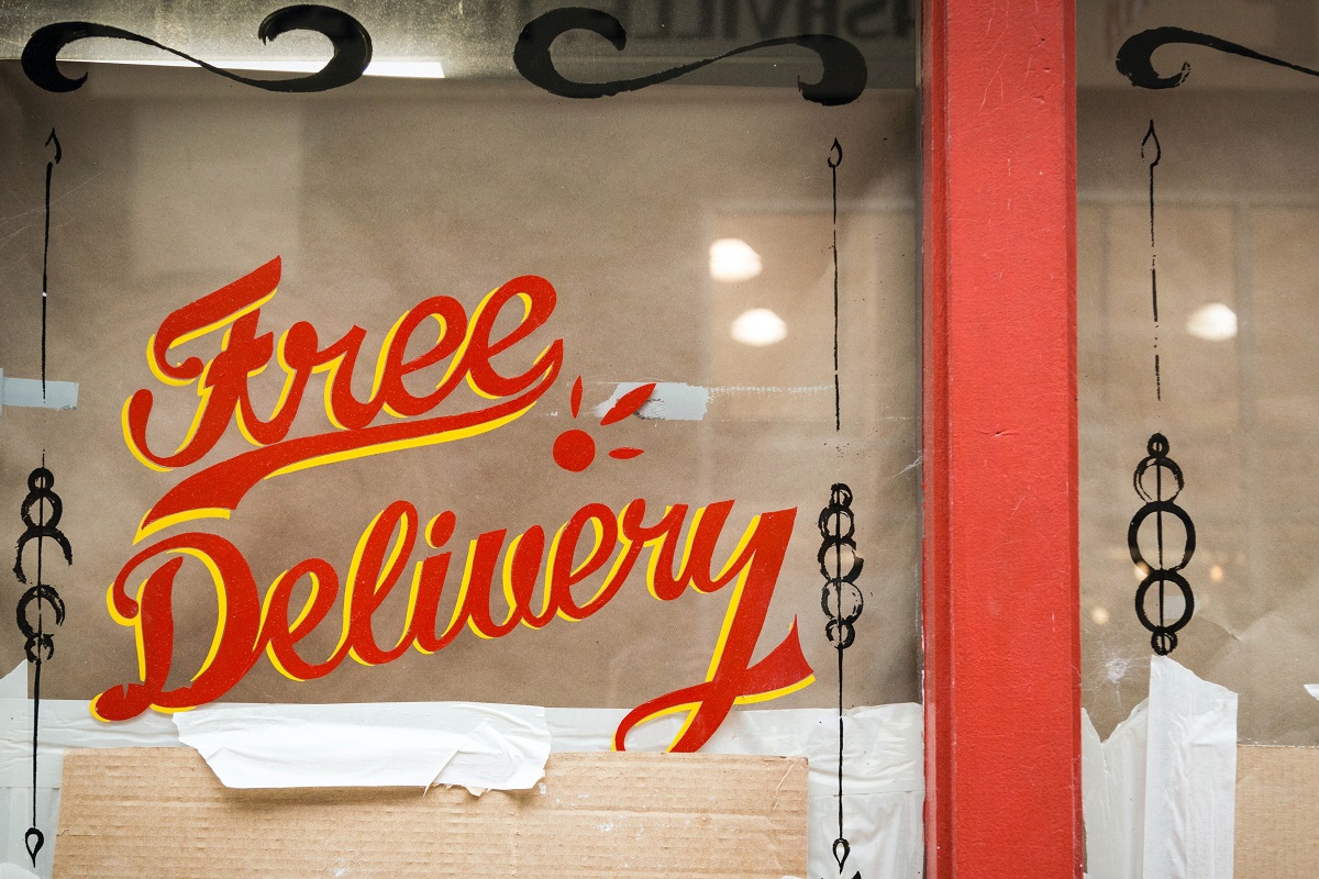 restaurant with free delivery sign in window