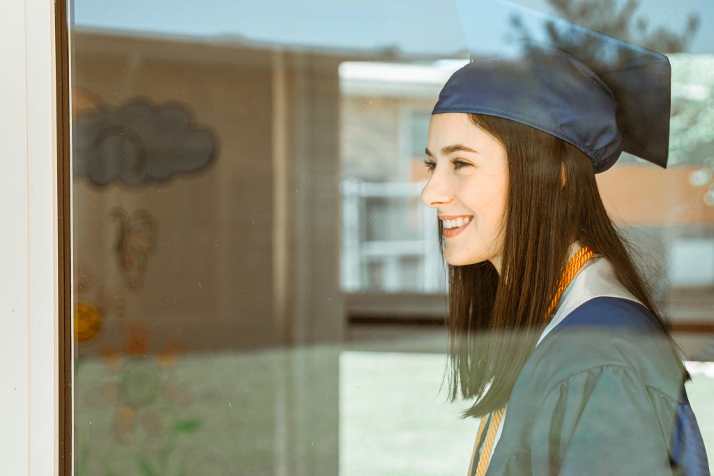 Female graduate looking out the window