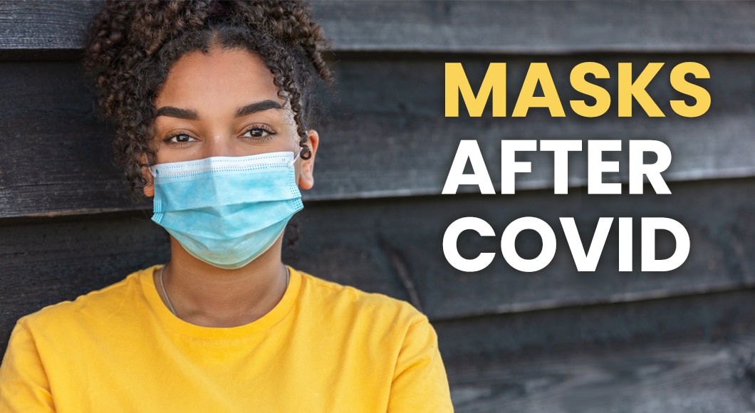 woman in yellow shirt wearing protective procedural face mask