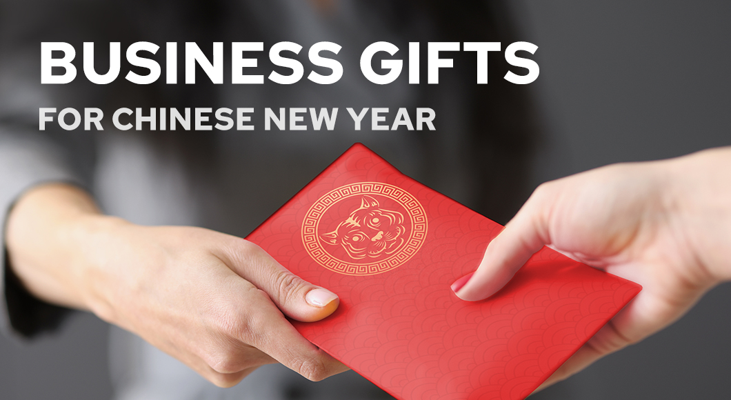 Hands of two professionals, giving and receiving red business gift to celebrate Chinese New Year