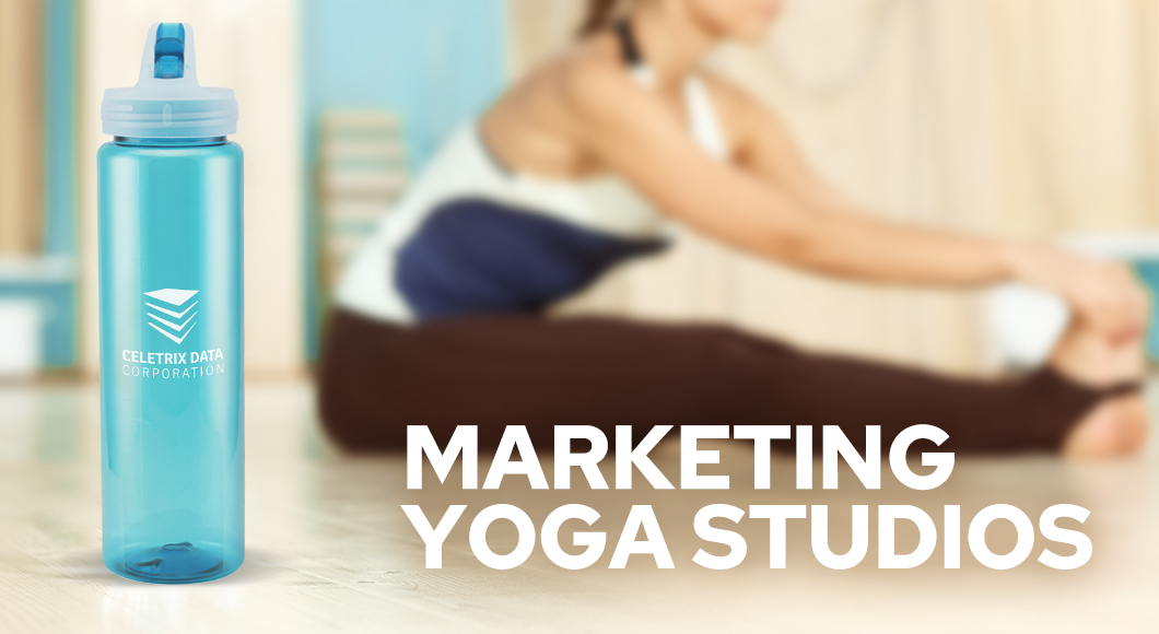 woman stretching in studio during yoga class with promotional water bottle in foreground to market the yoga studio