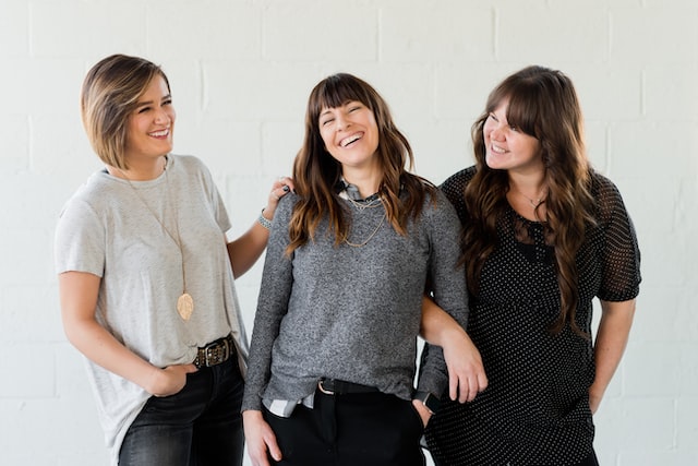 Three sisters laughing, representing family-owned business