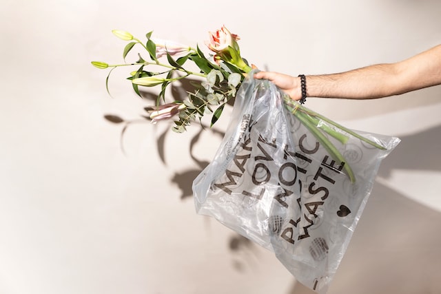 flowers in plastic bag with message encouraging use of rPET to eliminate and reduce plastic waste