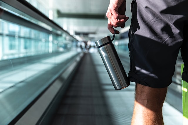 Traveler at airport with stainless steel tumbler