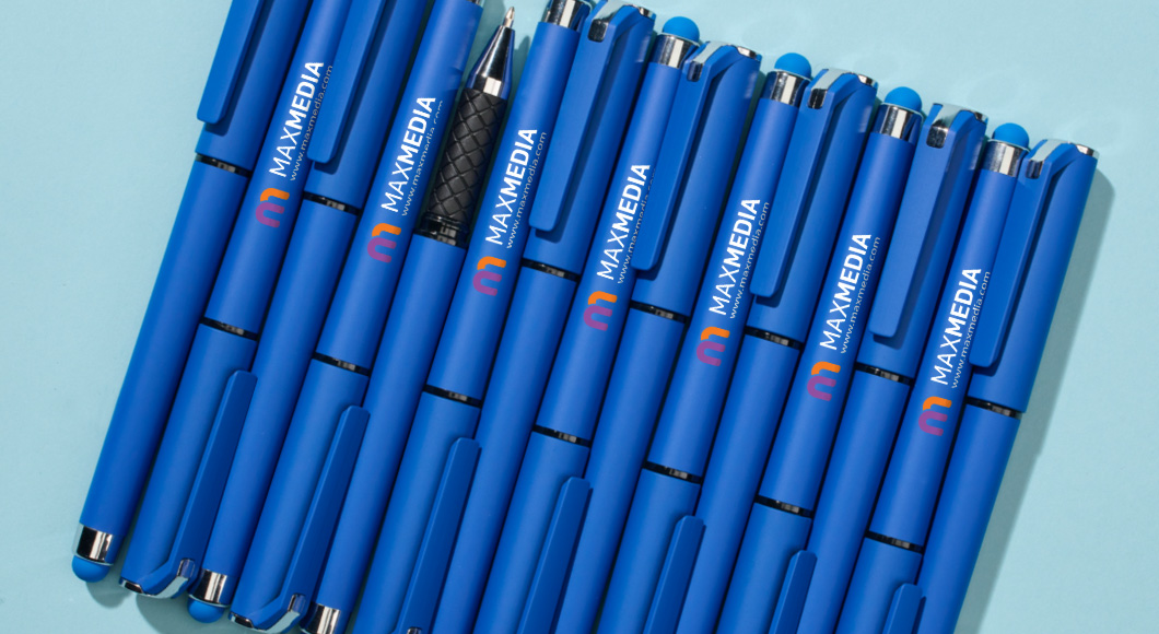 bright blue caps pens with matching stylus on light blue desk with new website promoted on pen barrels