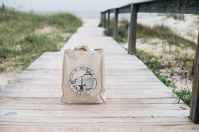 Jute summer tote bag with branding at beach