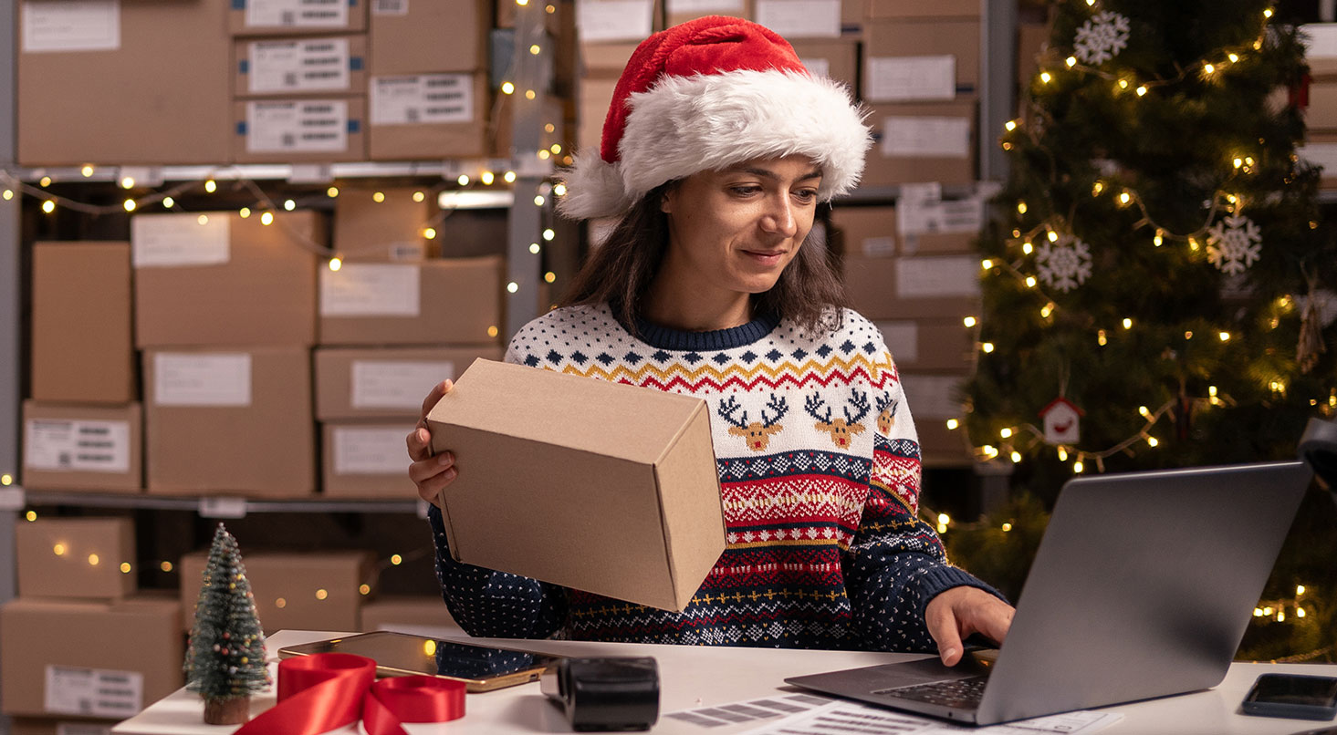 small business owner in Christmas clothing working during the busy holiday season