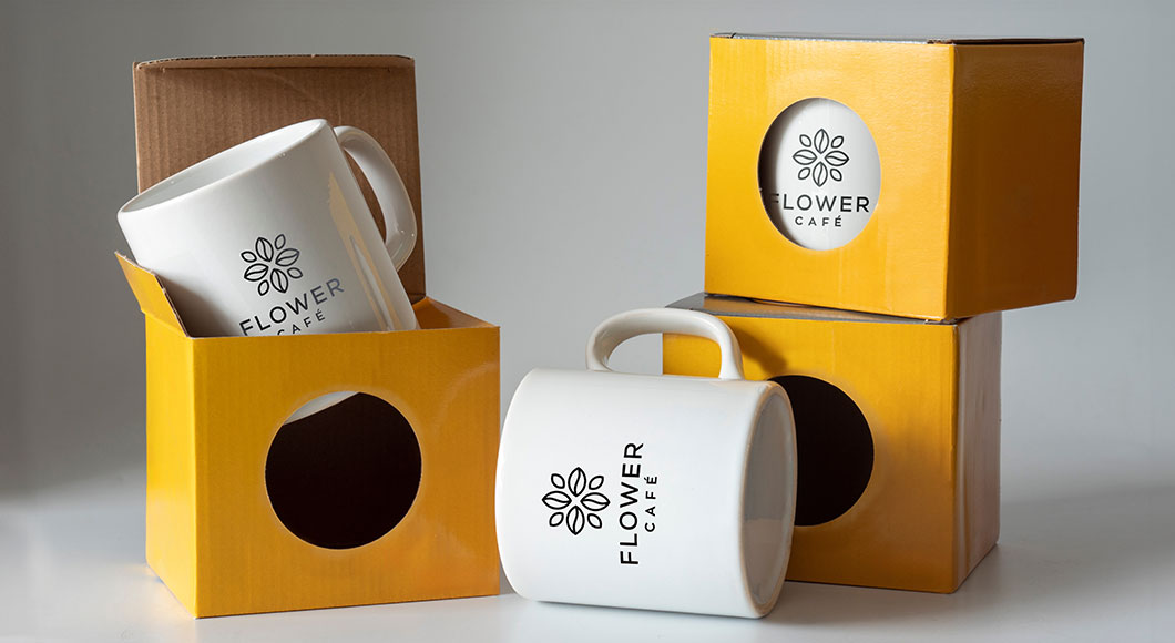 Custom mugs in gift boxes as sellable merchandise for coffee shop