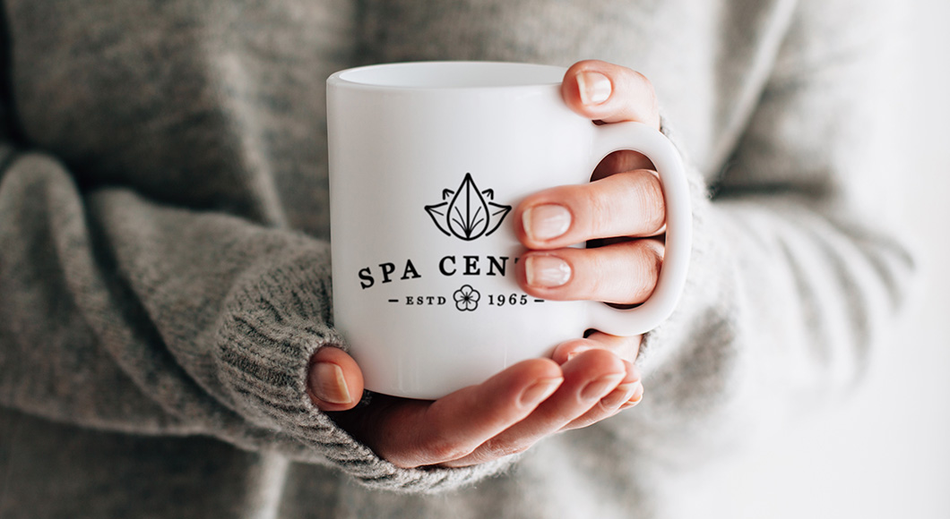 woman holding a mug with a custom logo printed on the front