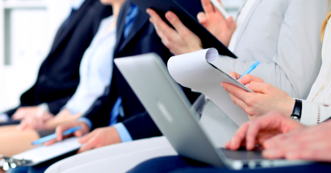 People Taking Notes at a Work Conference