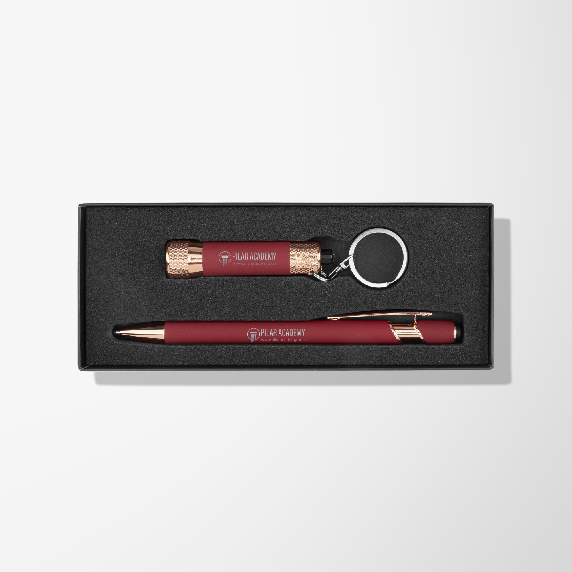Matching branded red pen and flashlight in black gift box.