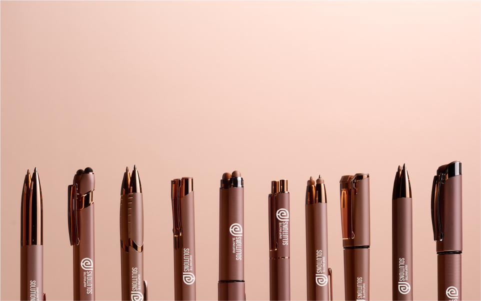 A dozen pens in rose gold colour with company logo and message printed