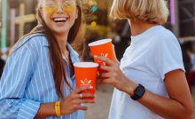 People attending a festival drinking with branded cups